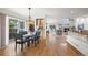 Open dining area with hardwood floors, glass table, and sliding glass doors to the outside deck at 2330 Sandpiper Dr, Lafayette, CO 80026