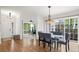 Dining room with hardwood floors, modern light fixture and a view to another room with three windows at 2330 Sandpiper Dr, Lafayette, CO 80026
