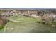 A large green field in a neighborhood, surrounded by houses and trees at 2330 Sandpiper Dr, Lafayette, CO 80026