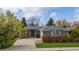 Charming single-story home featuring a well-manicured lawn, mature trees, and a welcoming front entrance at 2330 Sandpiper Dr, Lafayette, CO 80026