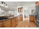Open kitchen with bar seating overlooking the living area, stainless appliances, and light wood cabinets at 2330 Sandpiper Dr, Lafayette, CO 80026