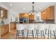 Well-appointed kitchen with breakfast bar, wooden cabinets, stainless steel appliances and hardwood floors at 2330 Sandpiper Dr, Lafayette, CO 80026