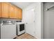 Functional laundry room with modern washer and dryer, and storage cabinets at 2330 Sandpiper Dr, Lafayette, CO 80026