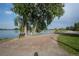 Scenic view of a lakeside path with a bench under shady trees at 2330 Sandpiper Dr, Lafayette, CO 80026
