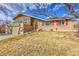 Charming brick home featuring a balcony, red shutters and door, and a well-maintained front yard at 7313 S Dexter Way, Centennial, CO 80122