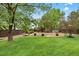 Large backyard with a grassy area, concrete patio, well-kept landscaping and wood fence at 9871 Indian Wells Dr, Lone Tree, CO 80124