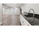 Finished basement featuring a wet bar, sink, and granite countertop, perfect for entertaining at 9871 Indian Wells Dr, Lone Tree, CO 80124