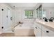 Bright primary bathroom featuring soaking tub, standing shower, and updated fixtures at 9871 Indian Wells Dr, Lone Tree, CO 80124