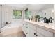 Primary bathroom suite with a double vanity, soaking tub, and glass shower; the perfect place to unwind at 9871 Indian Wells Dr, Lone Tree, CO 80124