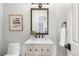 Charming powder room features a modern vanity with a wood-trimmed mirror and stylish fixtures at 9871 Indian Wells Dr, Lone Tree, CO 80124