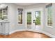 Breakfast nook features french doors to the outdoor patio and bright windows, with gray cabinets at 9871 Indian Wells Dr, Lone Tree, CO 80124