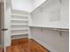 Spacious walk-in closet with hardwood floors, open shelving, and metal closet rods at 9871 Indian Wells Dr, Lone Tree, CO 80124
