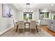 Elegant dining room with modern light fixture and access to the kitchen at 9871 Indian Wells Dr, Lone Tree, CO 80124