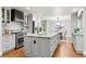 Spacious kitchen island with marble countertop, stainless steel appliances, and hardwood floors at 9871 Indian Wells Dr, Lone Tree, CO 80124
