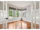 Spacious room with hardwood floors, natural light from the many windows, and a view of the outdoors at 9871 Indian Wells Dr, Lone Tree, CO 80124