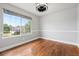 Bright room with large window with outside view, hardwood floors, and neutral paint at 9871 Indian Wells Dr, Lone Tree, CO 80124