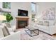 Cozy living room featuring a fireplace, large windows, and comfortable seating at 9871 Indian Wells Dr, Lone Tree, CO 80124