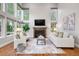 Cozy living room featuring a fireplace, large windows, and comfortable seating at 9871 Indian Wells Dr, Lone Tree, CO 80124
