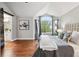 Spacious Primary bedroom with vaulted ceiling, large windows, hardwood floors, and a barn door leading to the bath at 9871 Indian Wells Dr, Lone Tree, CO 80124