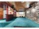 Finished basement with a wet bar, media screen, stone accent wall, and comfortable carpeting at 15740 Sandtrap Way, Morrison, CO 80465