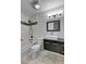 Updated bathroom featuring modern vanity, sleek fixtures, and tiled shower and tub at 15740 Sandtrap Way, Morrison, CO 80465