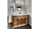 Bathroom with wooden vanity, decorative mirror, and ample lighting for a functional and stylish space at 15740 Sandtrap Way, Morrison, CO 80465
