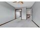 Comfortable bedroom with a large closet, ceiling fan, and convenient access to the hallway at 15740 Sandtrap Way, Morrison, CO 80465