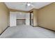 Light-filled bedroom with a ceiling fan, soft carpeting, closet, and easy access to the hallway at 15740 Sandtrap Way, Morrison, CO 80465