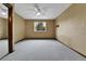 Inviting bedroom featuring plush carpet, neutral walls, ceiling fan, and bright window at 15740 Sandtrap Way, Morrison, CO 80465