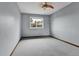 Spacious bedroom with plush carpet, ceiling fan, and a bright window with neighborhood views at 15740 Sandtrap Way, Morrison, CO 80465