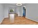 Open-concept living space with hardwood floors, a large window, and adjacent rooms for versatile living at 15740 Sandtrap Way, Morrison, CO 80465