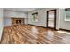This living room features a stone fireplace, wood floors, and an exterior door at 15740 Sandtrap Way, Morrison, CO 80465