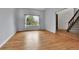 This living room features wood floors, natural light, and access to stairs at 15740 Sandtrap Way, Morrison, CO 80465