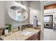 Bathroom featuring granite counters, a framed mirror, and a door leading to a balcony at 23785 Currant Dr, Golden, CO 80401