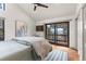 Bedroom featuring vaulted ceilings, sliding doors to a balcony, and mountain views at 23785 Currant Dr, Golden, CO 80401