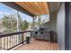 Covered deck featuring a grill with a serene view of the surrounding trees at 23785 Currant Dr, Golden, CO 80401