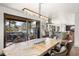 Bright dining room with modern chandelier and sliding glass doors opening to an outdoor deck area at 23785 Currant Dr, Golden, CO 80401