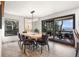 Dining room with modern chandelier, mountain views from the outdoor deck at 23785 Currant Dr, Golden, CO 80401