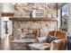Close-up of a stone fireplace with a wooden mantel and comfortable seating at 23785 Currant Dr, Golden, CO 80401