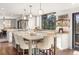 Bright kitchen with island, granite counters, stylish pendants, and wood floors at 23785 Currant Dr, Golden, CO 80401