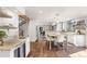Spacious, bright kitchen with island, granite counters, and wood floors at 23785 Currant Dr, Golden, CO 80401