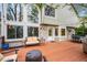 Back deck with outdoor seating, grill, and views to a large backyard with expansive windows and a brick exterior at 7954 S Franklin Ct, Centennial, CO 80122