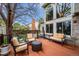 A furnished back deck features a seating area that overlooks a well-manicured yard and beautiful landscaping at 7954 S Franklin Ct, Centennial, CO 80122
