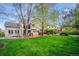 Backyard with grass, wooden deck with furniture and a large house at 7954 S Franklin Ct, Centennial, CO 80122