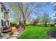 Backyard with grass, landscaping and large wooden deck with furniture at 7954 S Franklin Ct, Centennial, CO 80122