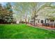Backyard with grass, landscaping, storage shed and wooden deck with furniture at 7954 S Franklin Ct, Centennial, CO 80122