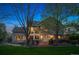 A landscaped backyard featuring a spacious deck perfect for entertaining, large windows, and lush greenery at 7954 S Franklin Ct, Centennial, CO 80122