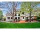 Large backyard with wooden deck, patio furniture, brick and siding home at 7954 S Franklin Ct, Centennial, CO 80122
