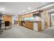 Basement kitchenette featuring wood cabinets, microwave, mini fridge, and sink at 7954 S Franklin Ct, Centennial, CO 80122