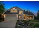 Charming two-story home features a well-manicured lawn, a brick and siding facade, and an attached two-car garage at 7954 S Franklin Ct, Centennial, CO 80122